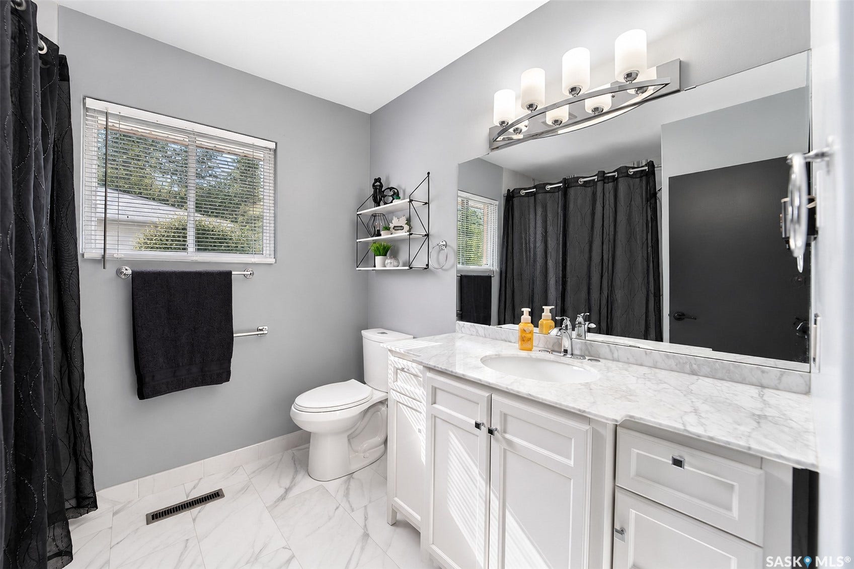 White vanity with a single basin, marble-finish countertop, and chrome faucet