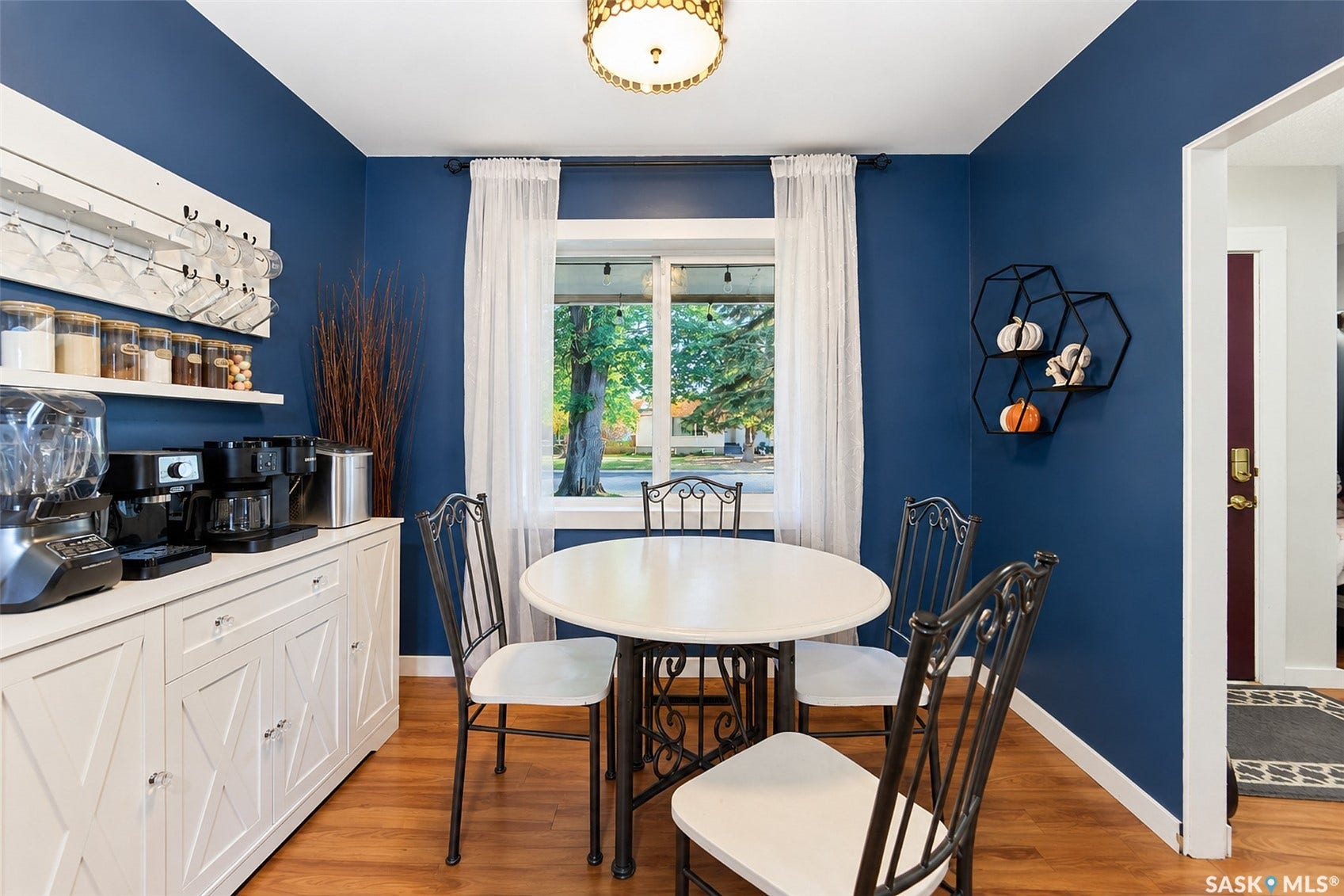 Hardwood-finish flooring, built-in shelving, and a prominent window