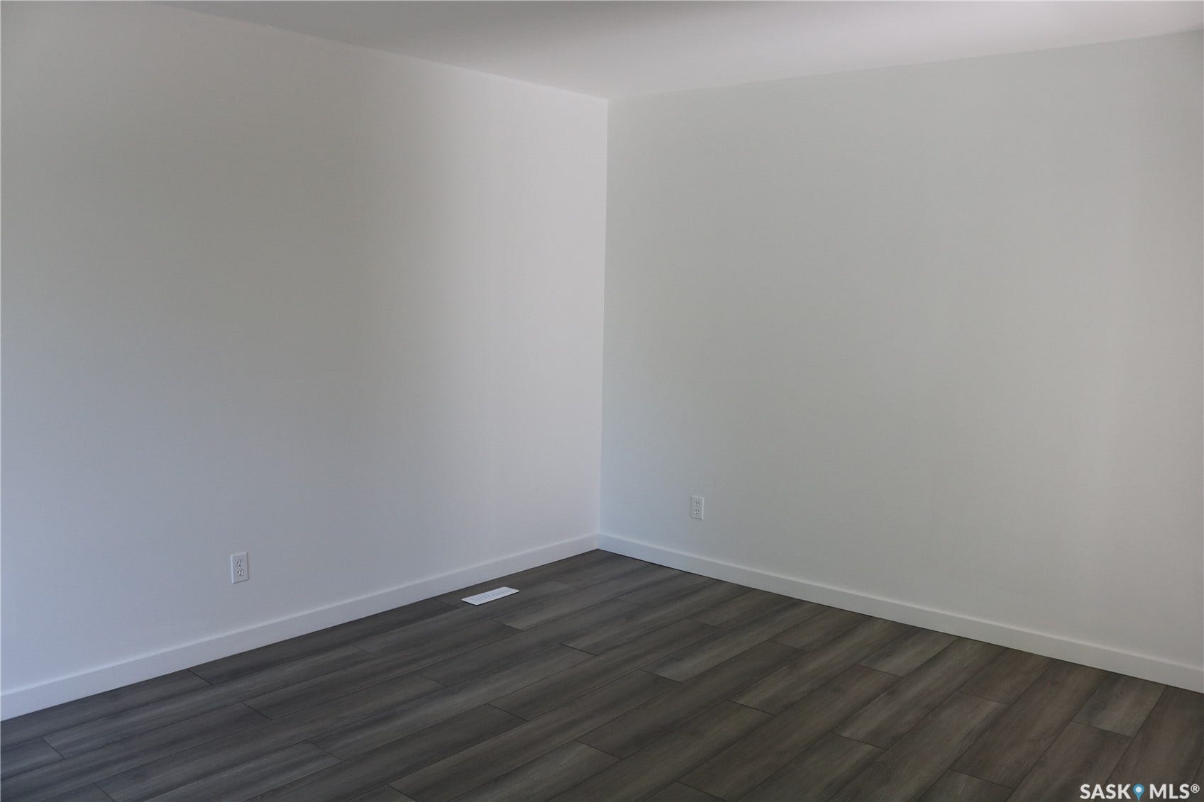 1641 Thompson Avenue, Saskatoon SK S7N 1Y2 Laminate flooring with white baseboards and neutral wall tones