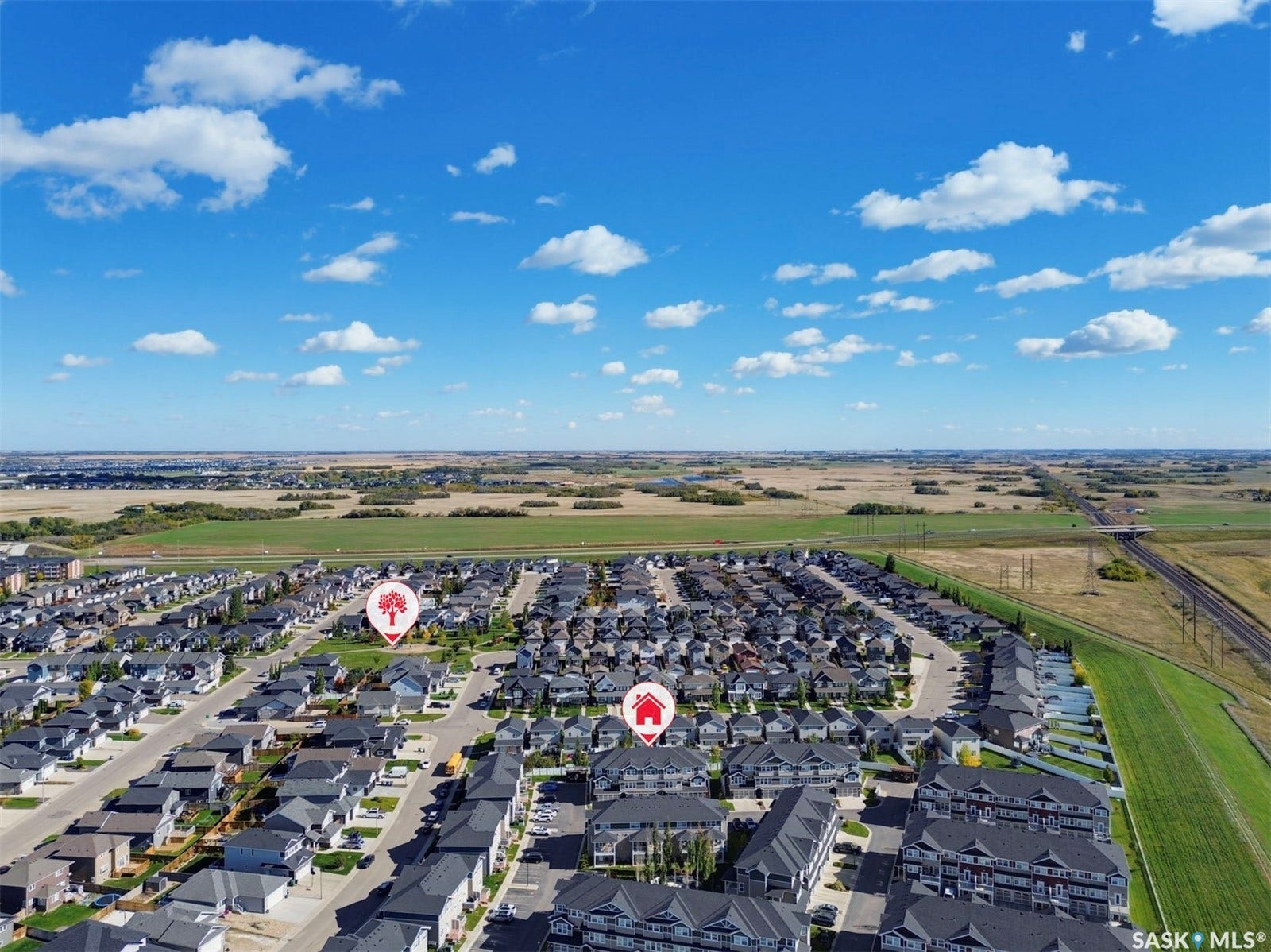 Aerial perspective of a residential neighborhood with a mix of detached homes and townhomes