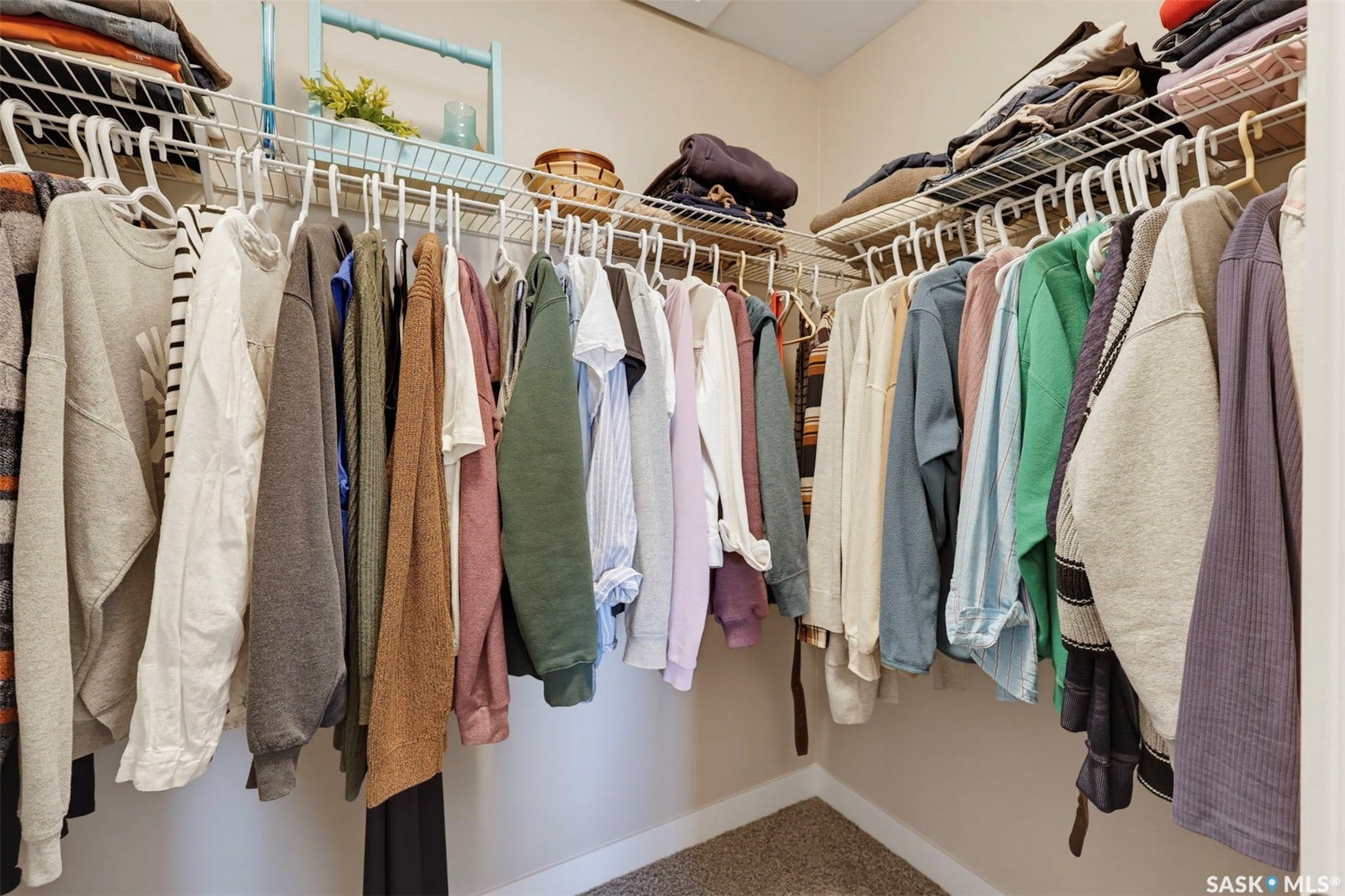 Walk-in closet featuring wire shelving and hanging rods