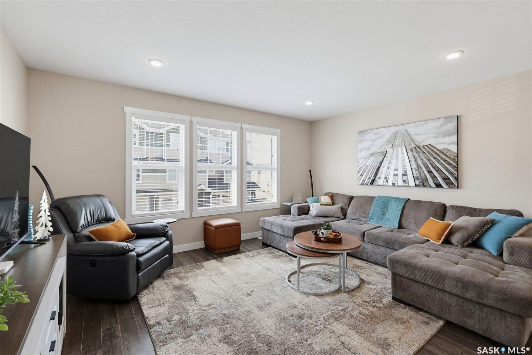 Recessed lighting, wood-finish flooring, white trim, and multiple large windows