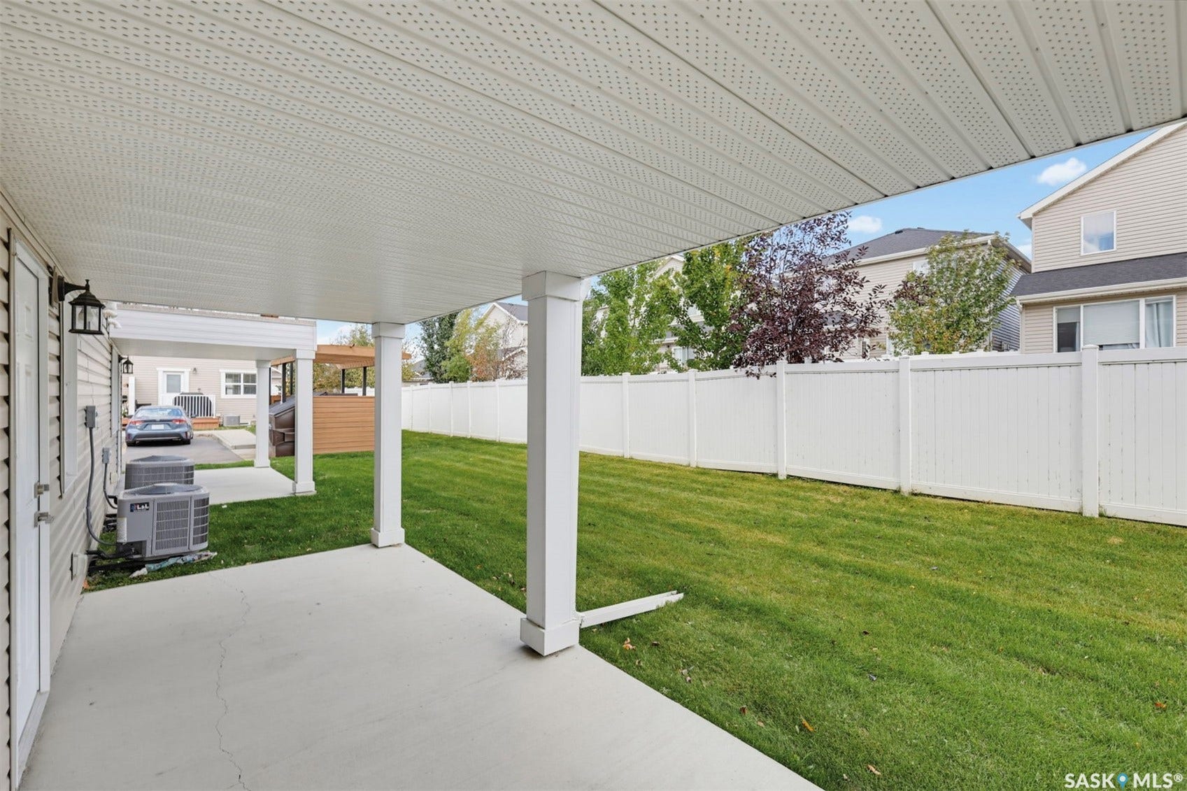 Covered patio space featuring a concrete slab and white support columns