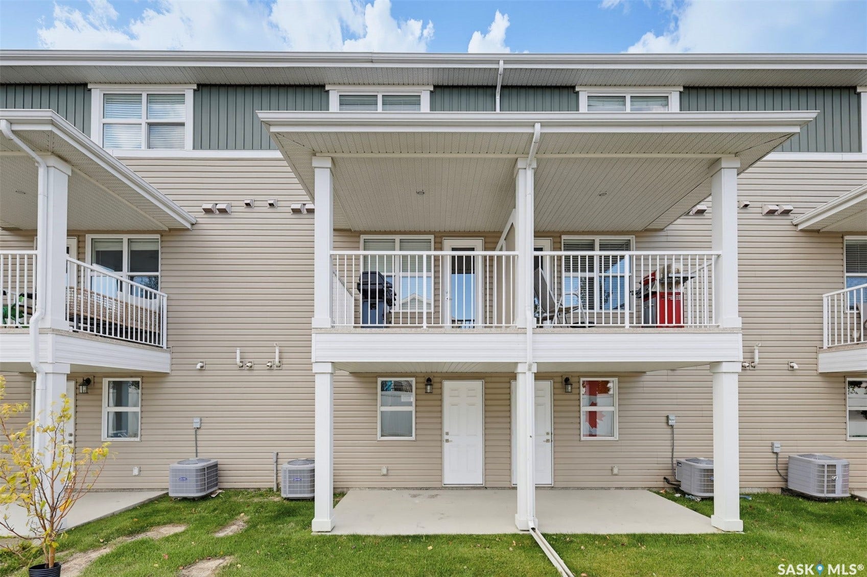 Multi-level building with vinyl siding and a covered balcony
