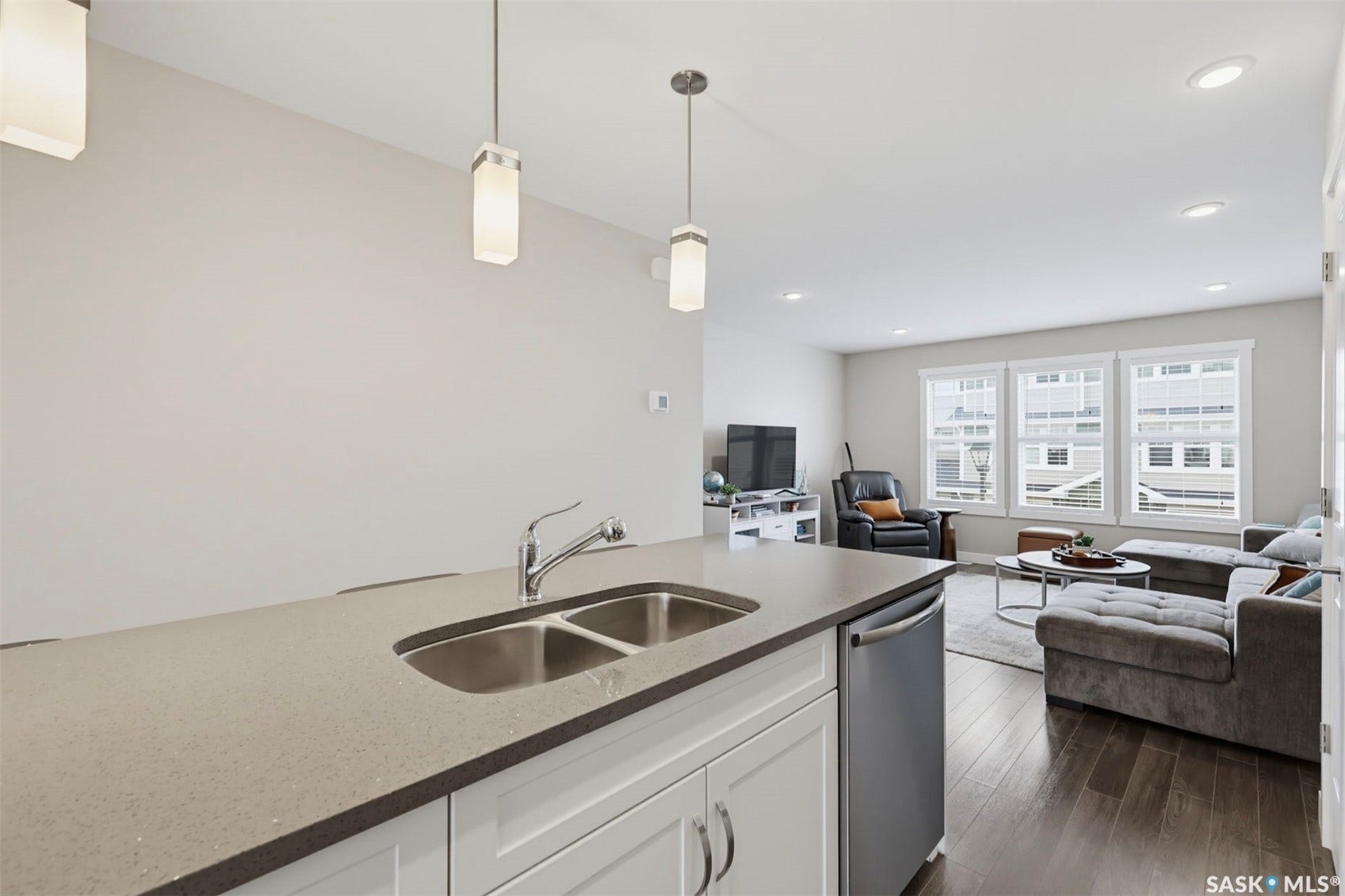 Kitchen island with a double basin sink, chrome faucet, and integrated dishwasher