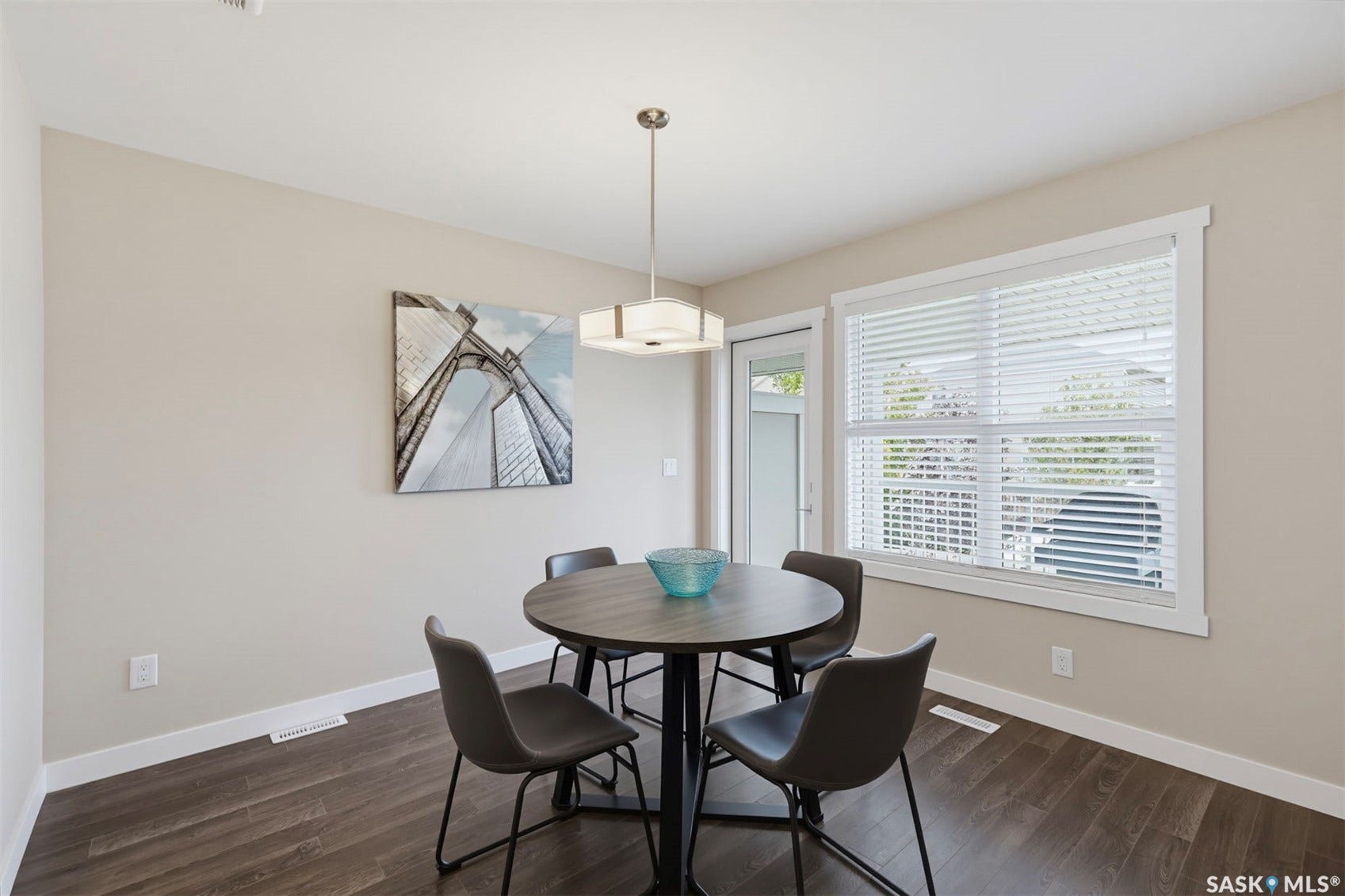 Wood-finish flooring, recessed lighting, and a white trim window