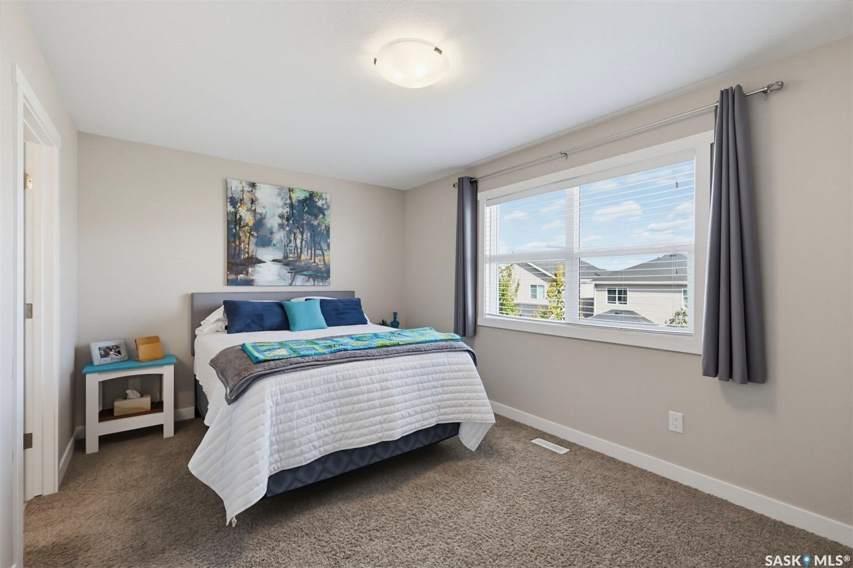 Neutral-toned walls complement the plush carpet flooring