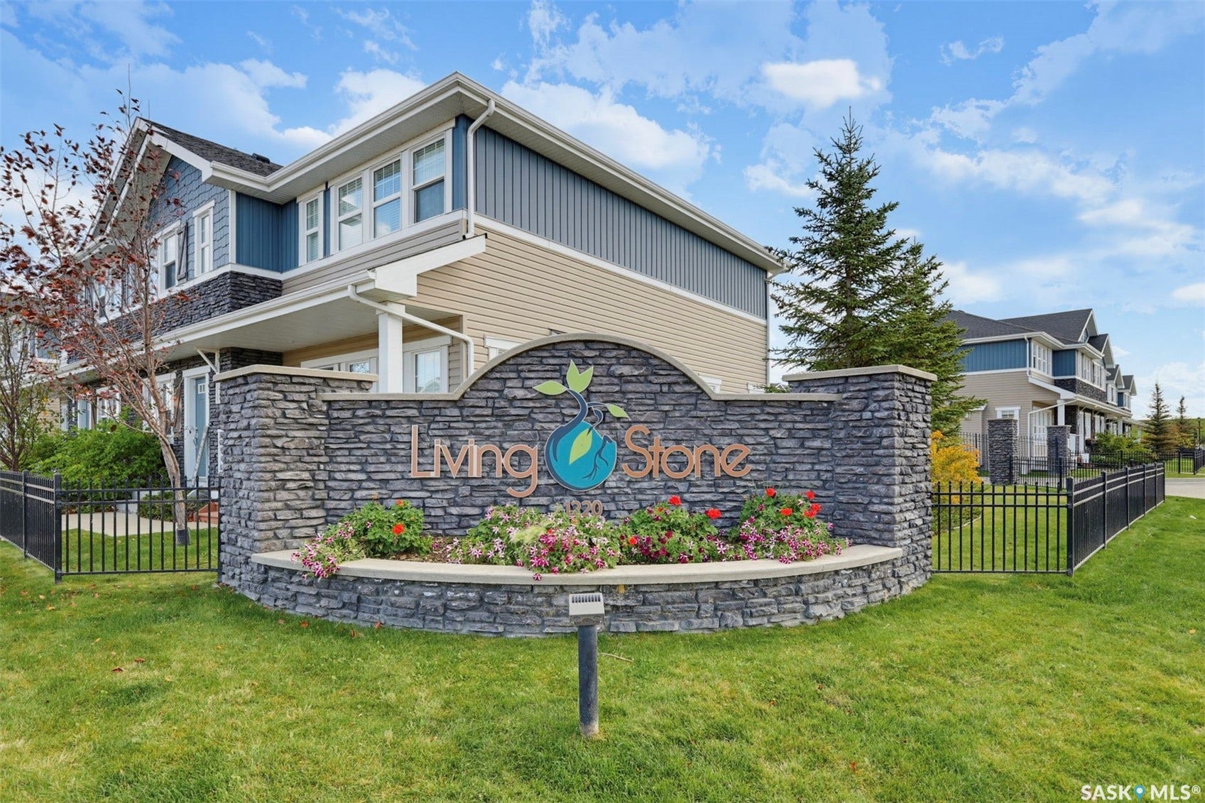 Stone-clad entry monument with vibrant landscaping
