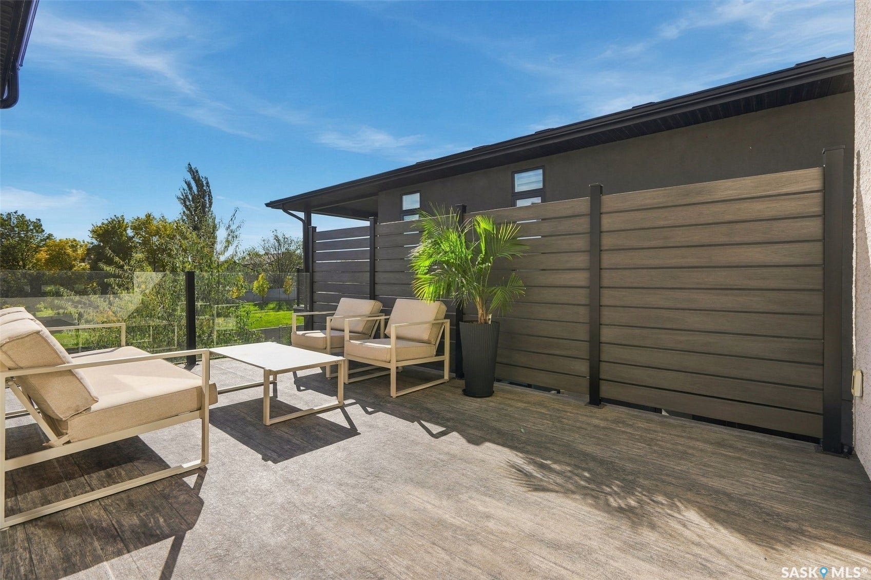 6221 Koep Avenue, Regina SK S4X 0J2 Expansive outdoor deck with composite decking, glass railing, and privacy screen