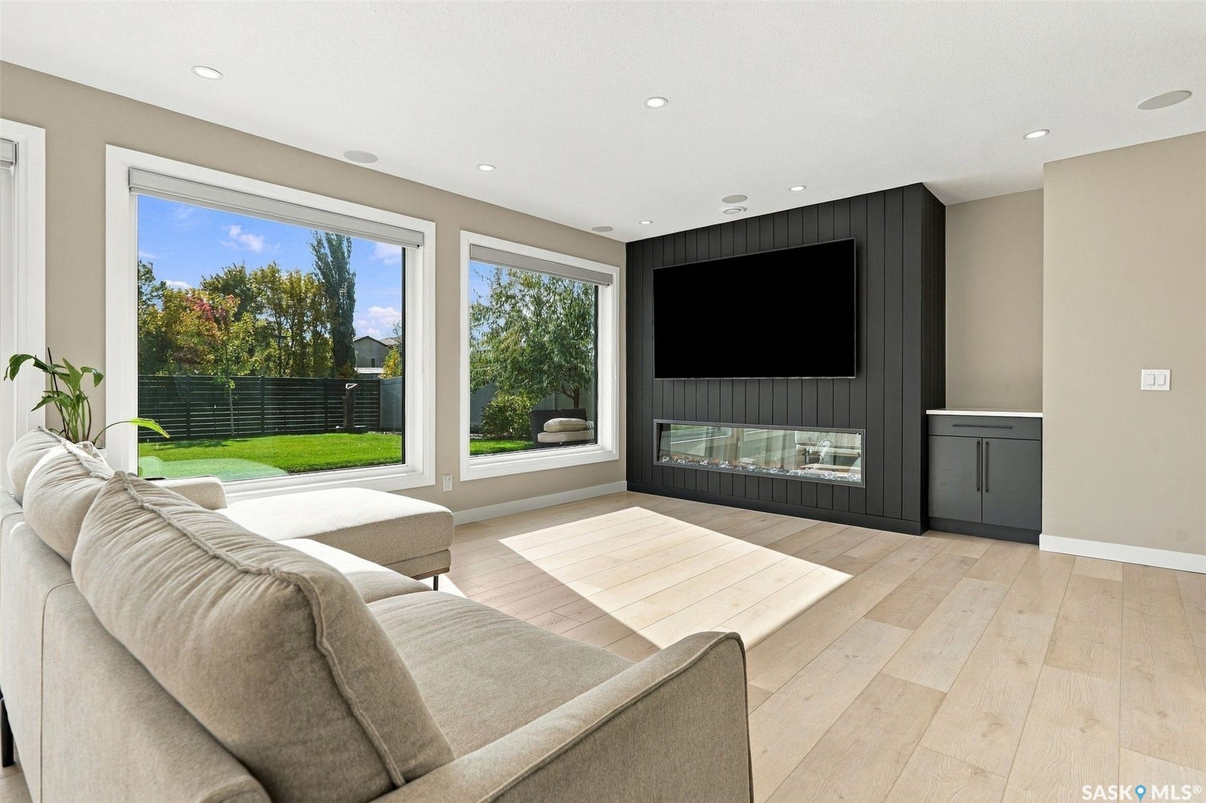 6221 Koep Avenue, Regina SK S4X 0J2 Expansive windows, wood-finish flooring, recessed lighting, built-in fireplace, and integrated cabinetry