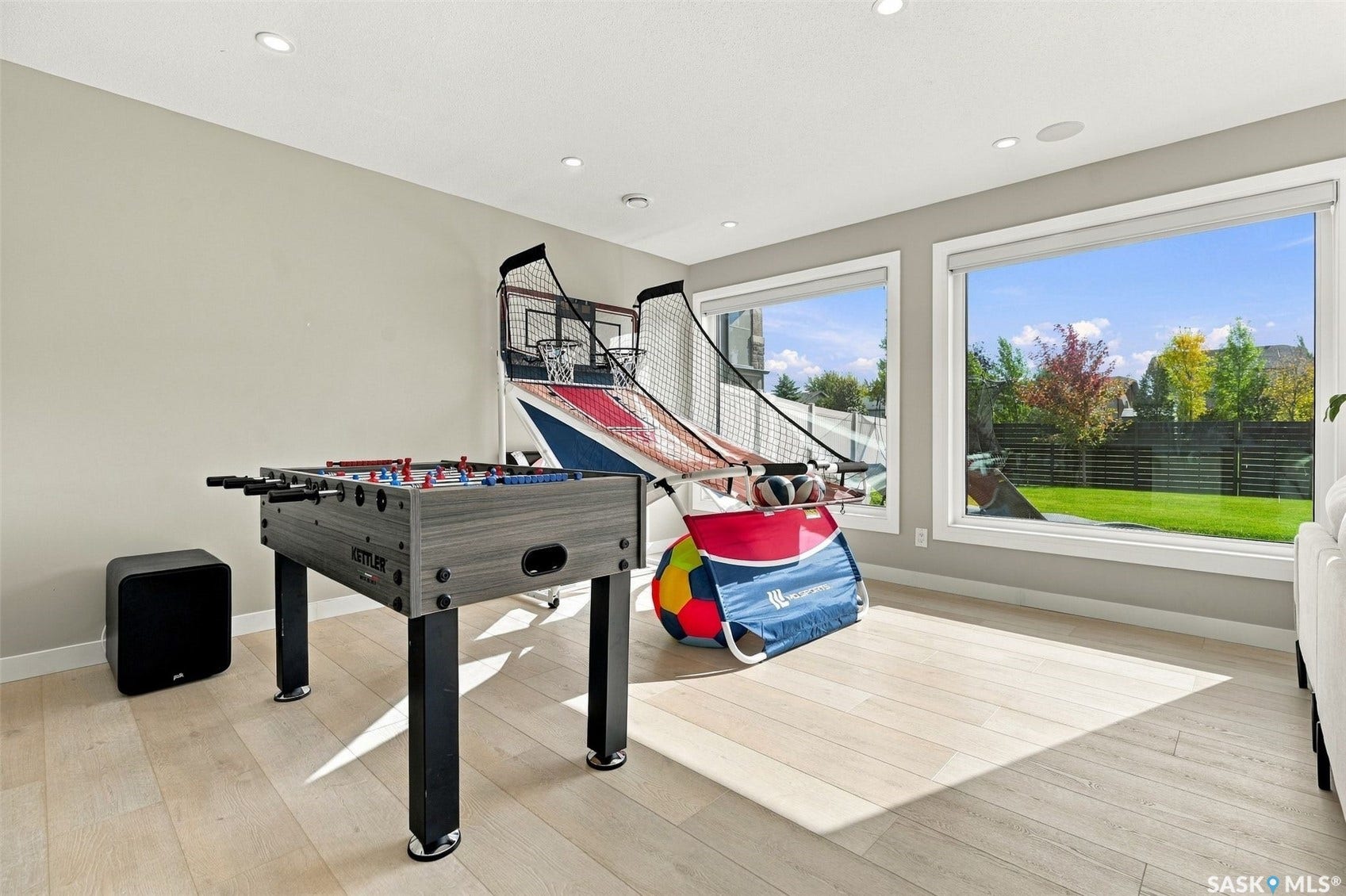 6221 Koep Avenue, Regina SK S4X 0J2 Recessed lighting, light wood-finish flooring, and large windows with white trim