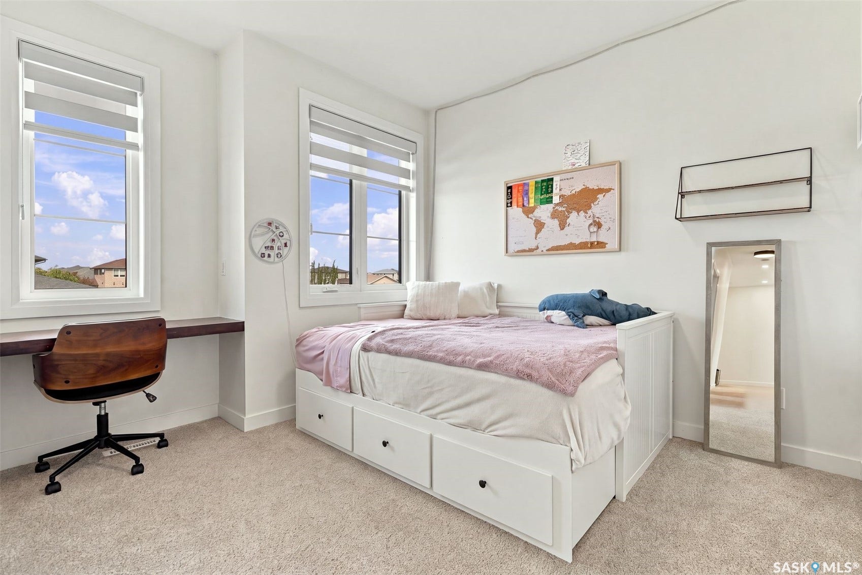 6221 Koep Avenue, Regina SK S4X 0J2 White walls, two windows with blinds, built-in desk, built-in bed frame with drawers, and carpeted flooring
