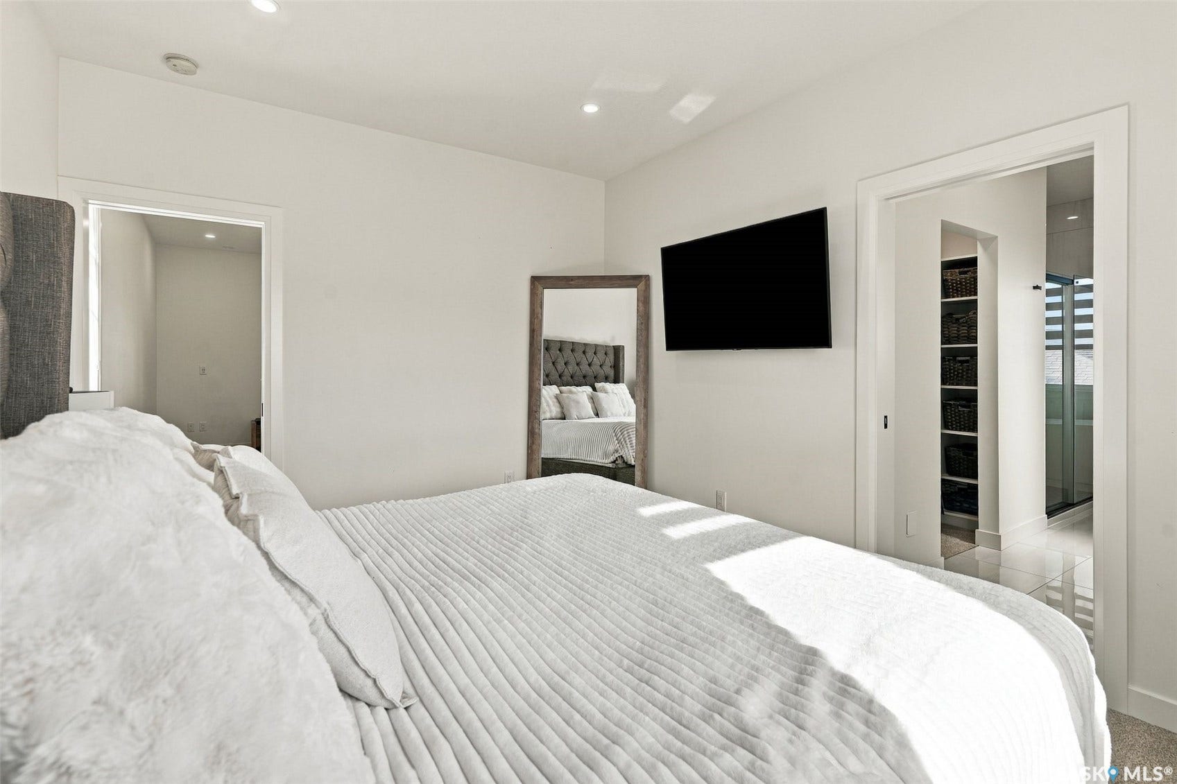 6221 Koep Avenue, Regina SK S4X 0J2 Recessed lighting illuminates the space, featuring a television mounted on the wall and a doorway leading to an additional space