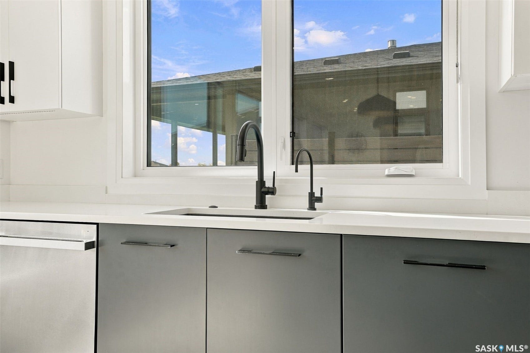 6221 Koep Avenue, Regina SK S4X 0J2 White framed window over a rectangular undermount sink, black gooseneck faucet, and stainless steel dishwasher