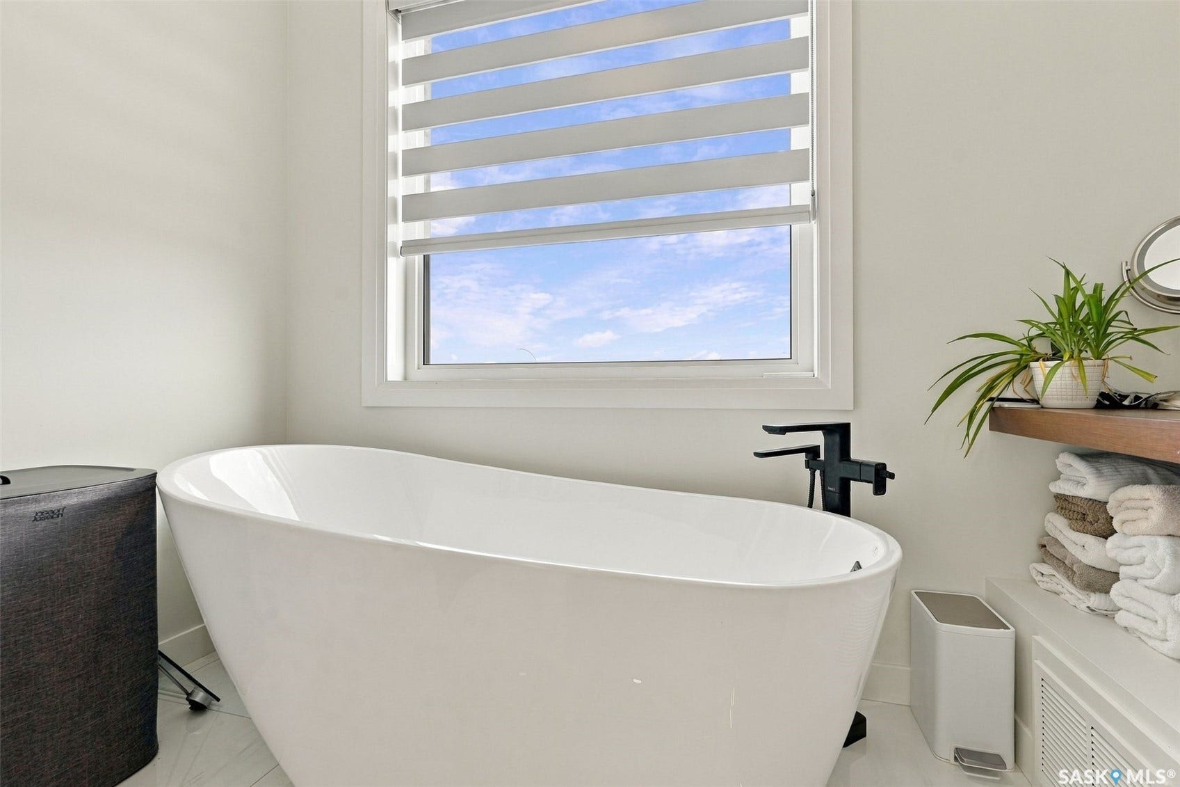6221 Koep Avenue, Regina SK S4X 0J2 Freestanding soaking tub with a floor-mounted matte black faucet