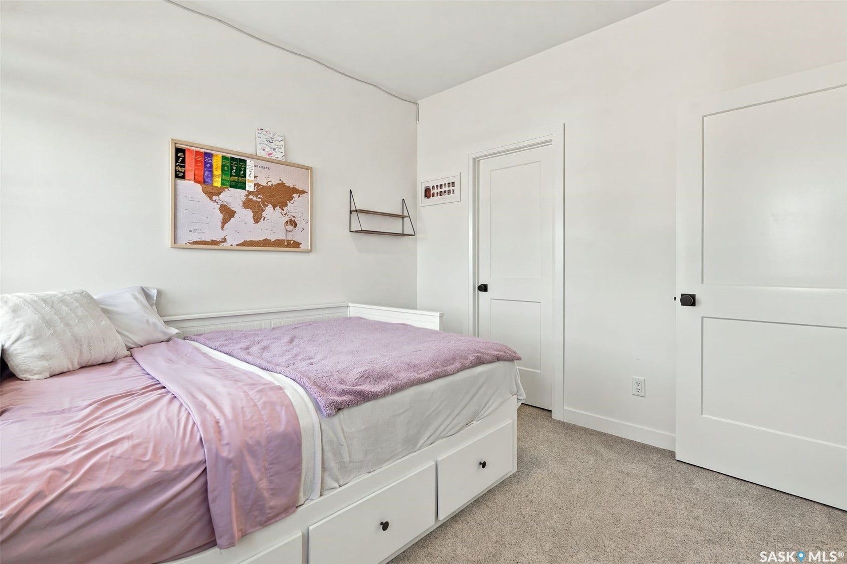 6221 Koep Avenue, Regina SK S4X 0J2 White paneled doors with matte black hardware, light-toned carpeting, and light-colored walls