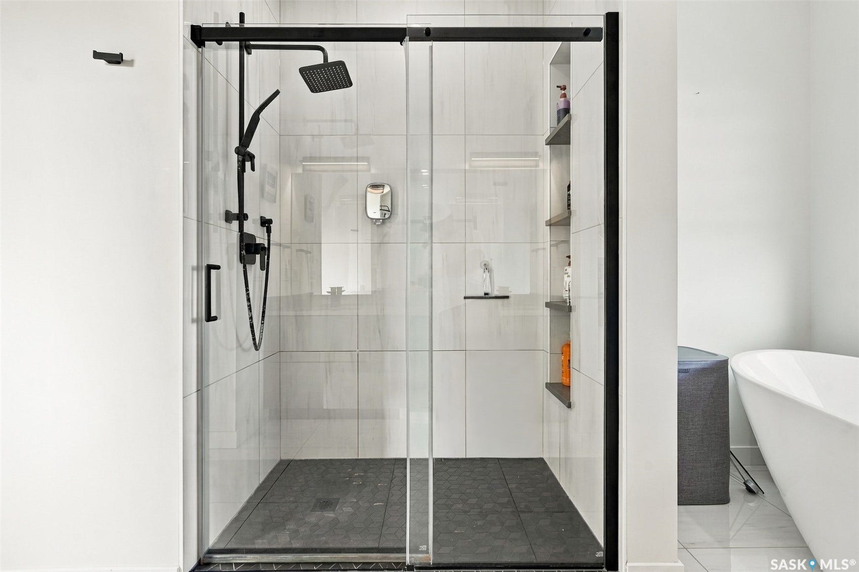 6221 Koep Avenue, Regina SK S4X 0J2 Walk-in shower with black-framed glass enclosure, square shower head, hexagonal floor tile, and built-in shelving