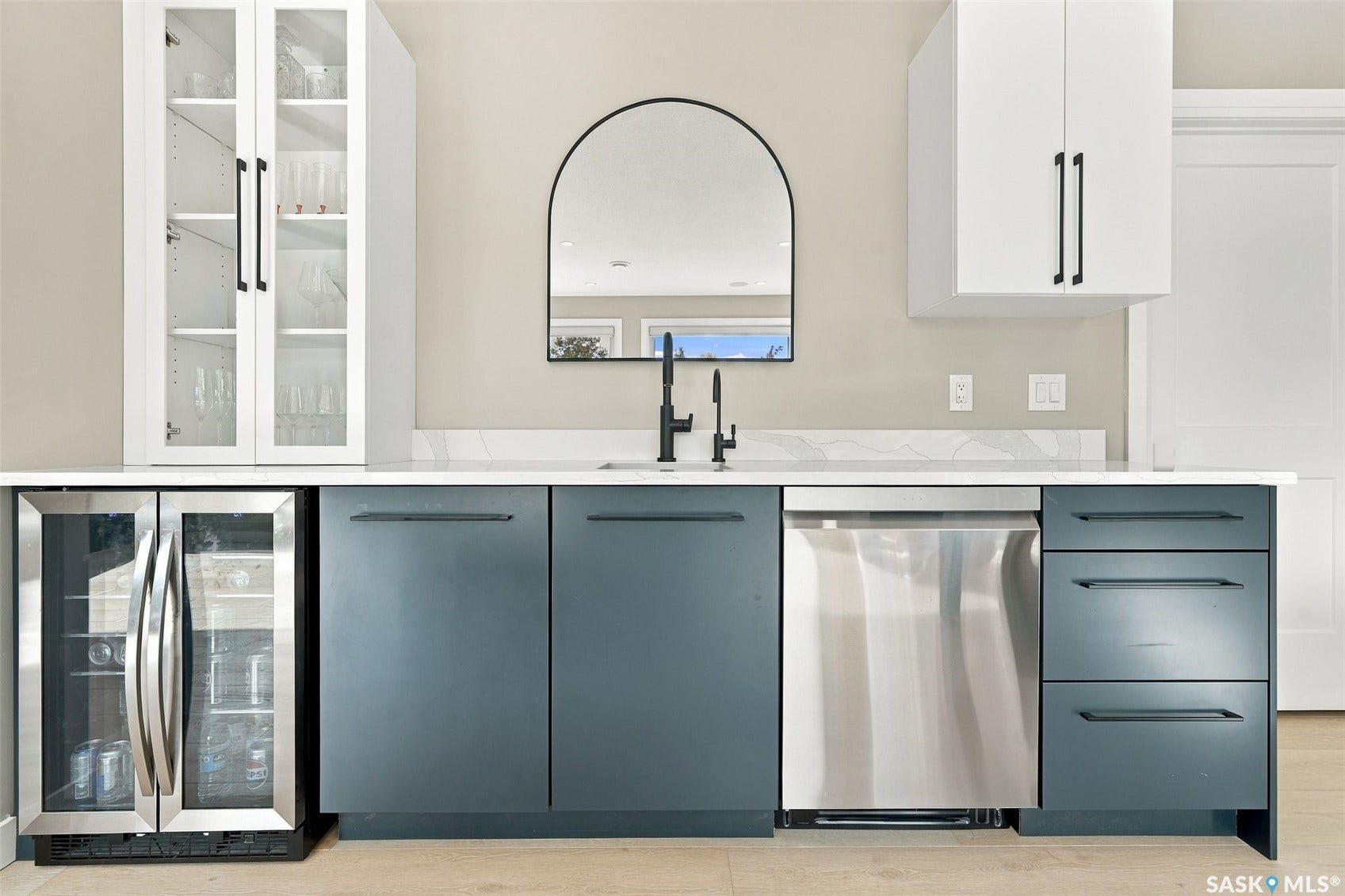 6221 Koep Avenue, Regina SK S4X 0J2 Wet bar featuring a stainless steel beverage refrigerator, white upper cabinetry with glass inserts, blue lower cabinetry, and a stainless steel dishwasher