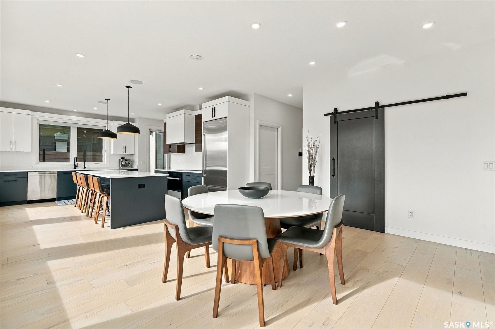 6221 Koep Avenue, Regina SK S4X 0J2 Open-concept kitchen and dining area featuring light-toned wood-finish flooring