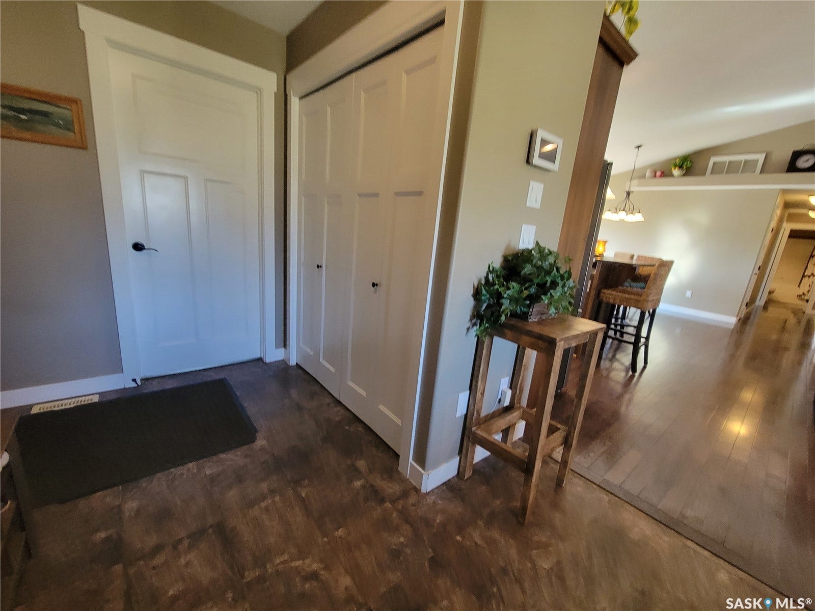 Wood-finish flooring throughout, white paneled doors, and light neutral wall tones