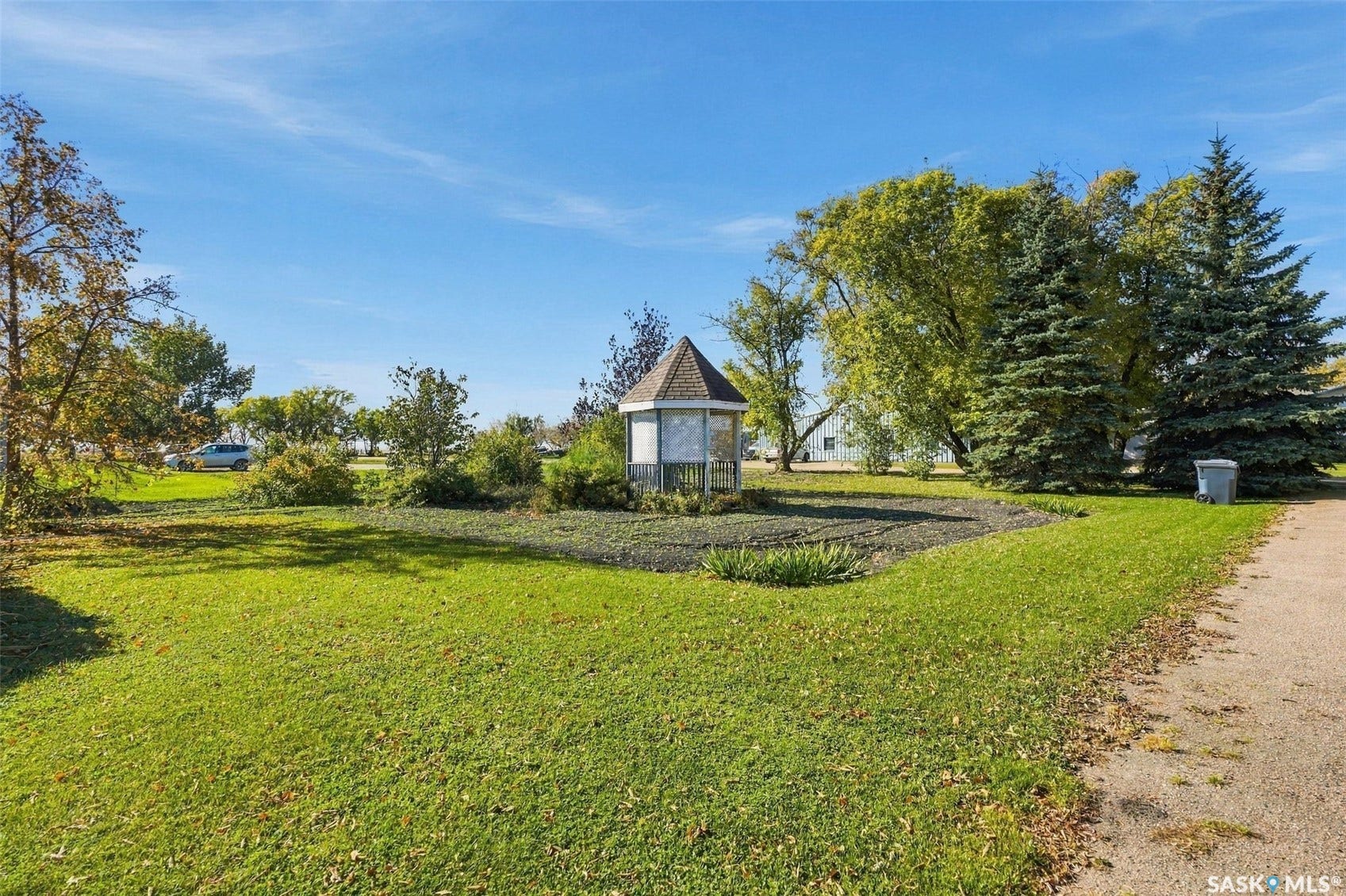 Expansive lawn with mature trees and a decorative gazebo