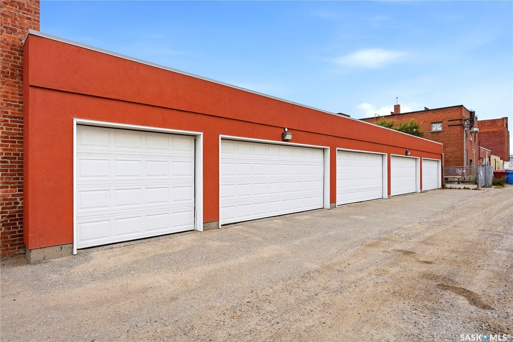 Four paneled garage doors set into a textured red exterior