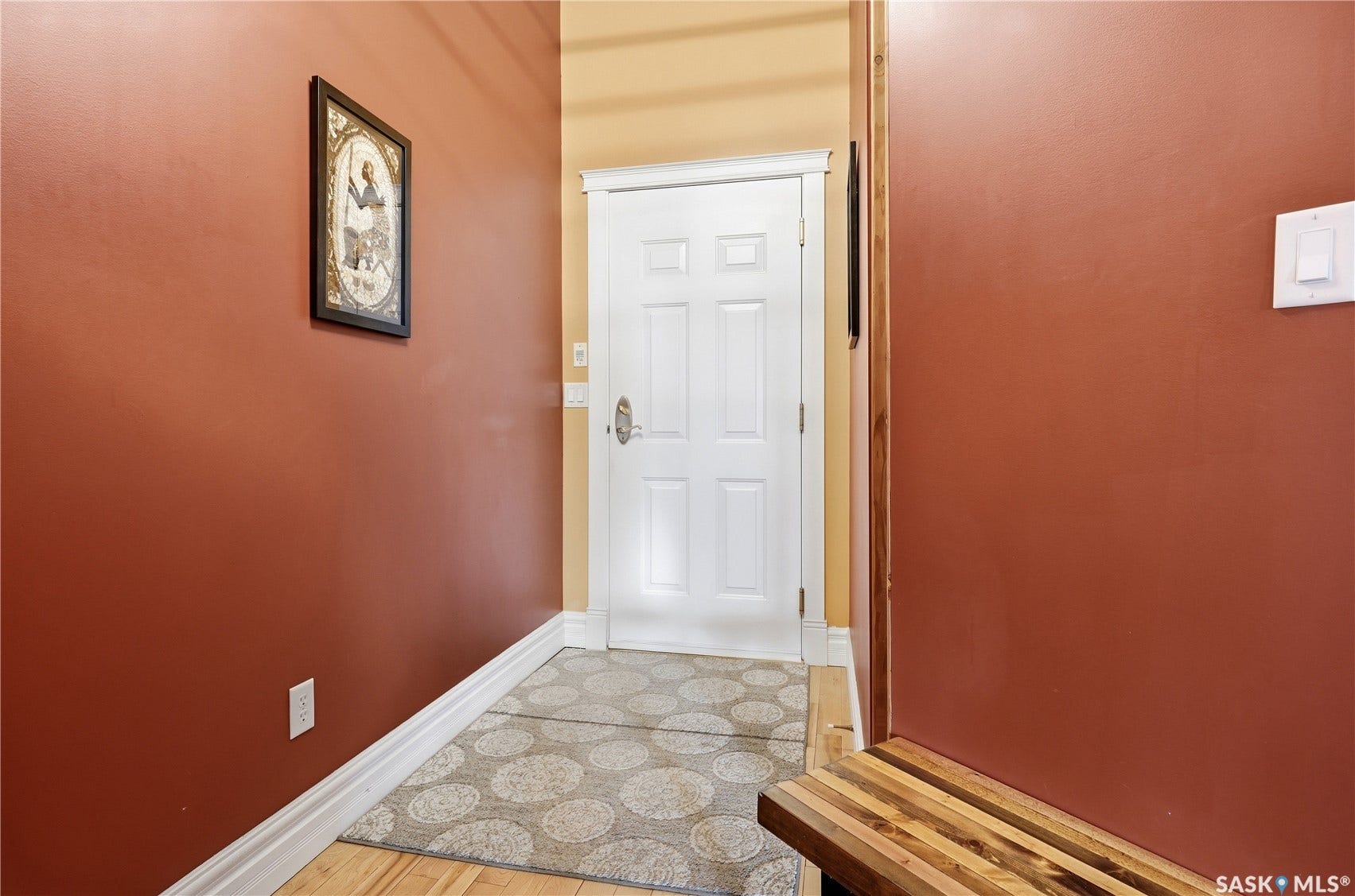 Wood-finish flooring with crisp white baseboards
