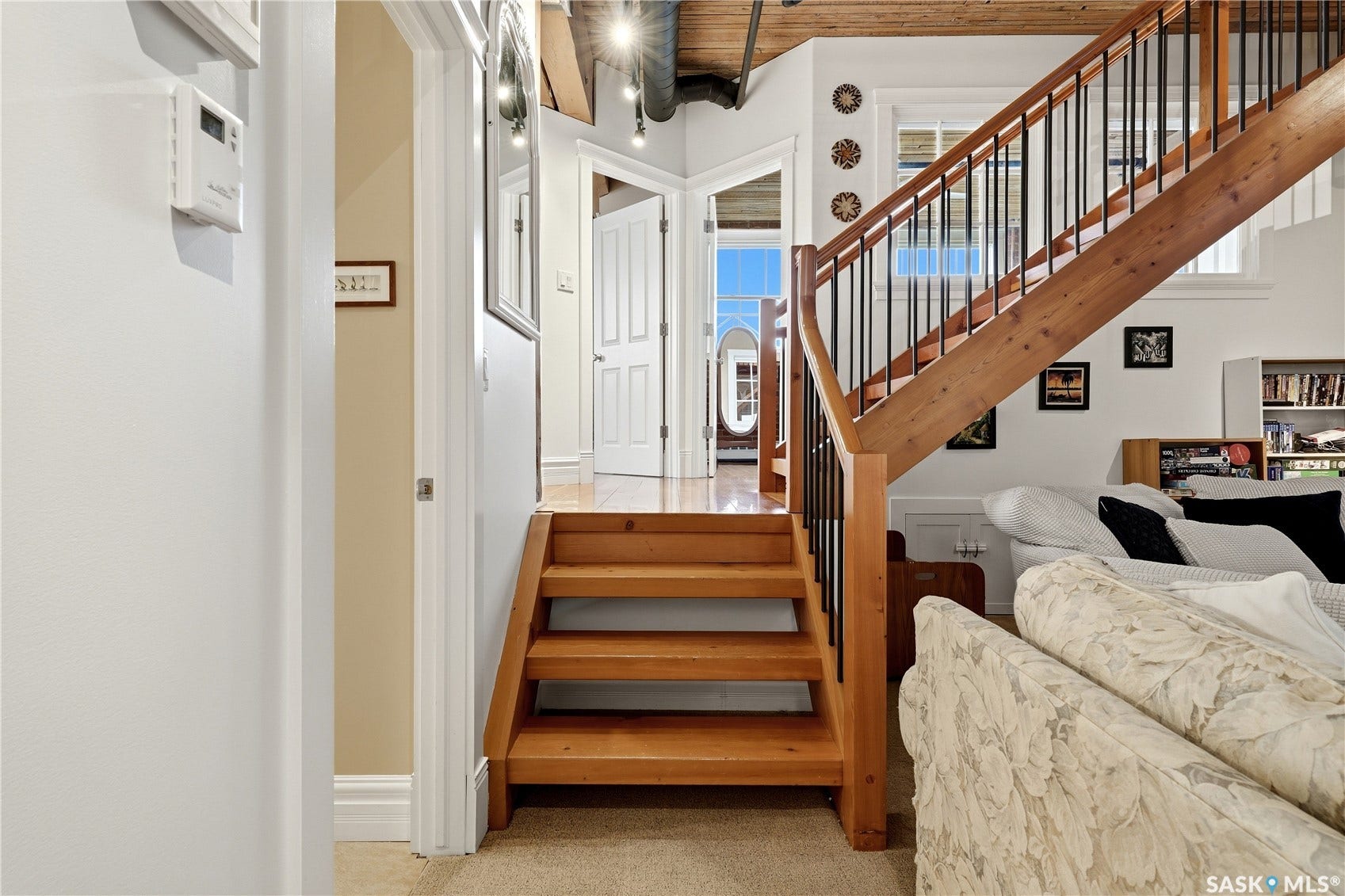 Wood staircase with black metal balusters