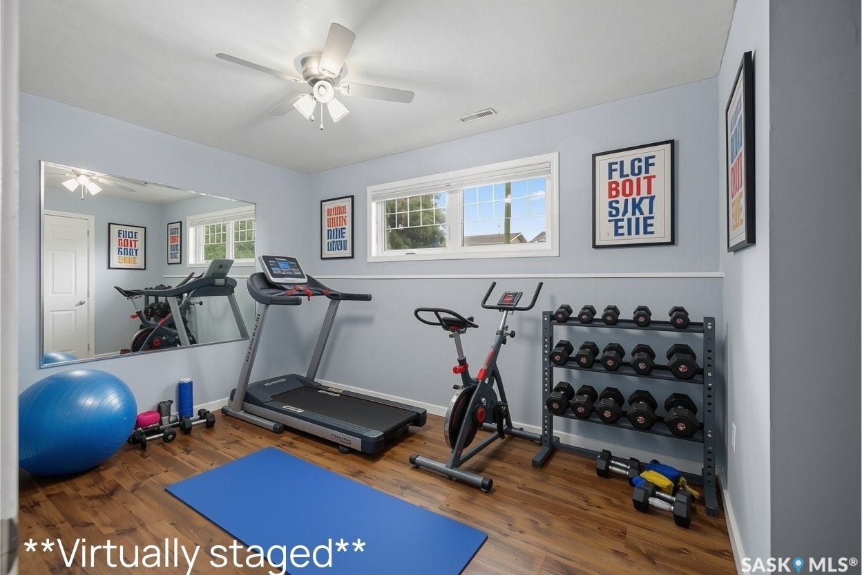 Wood-finish flooring, light blue wall paint, and a ceiling fan with integrated lighting