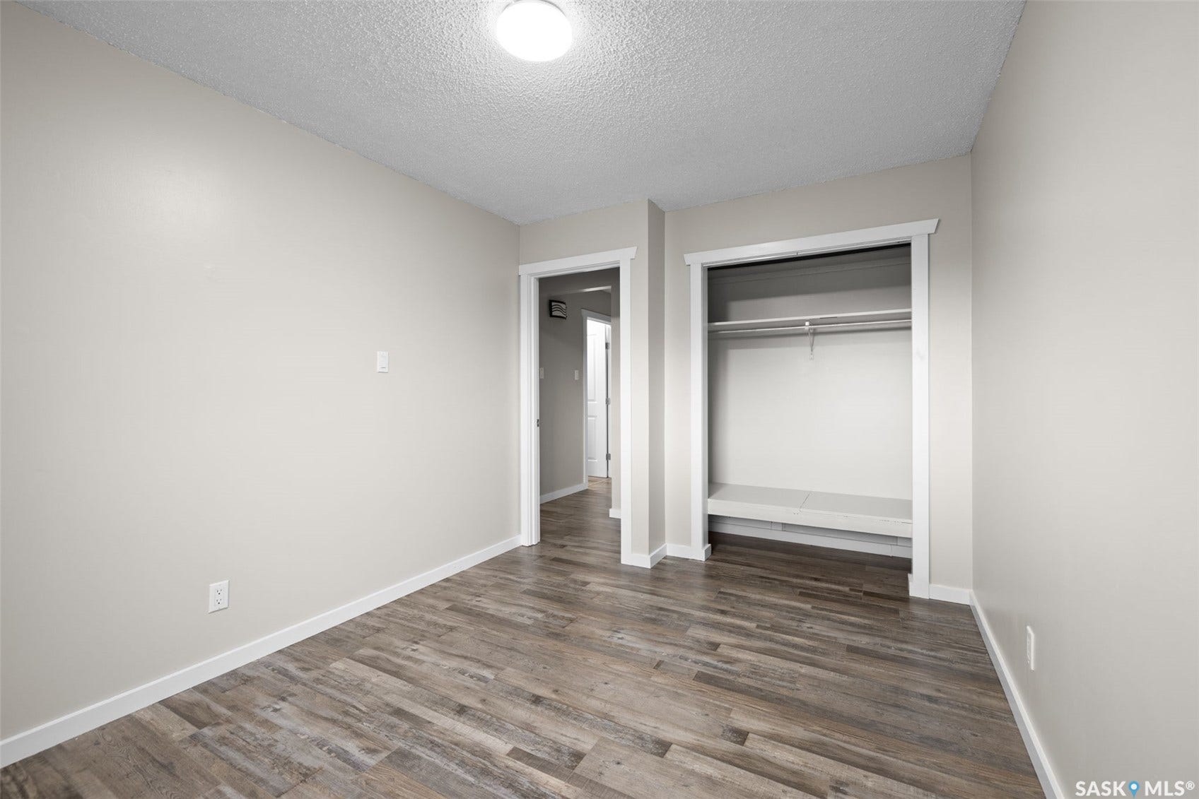 Wood-finish flooring, light neutral wall paint, and white trim accents