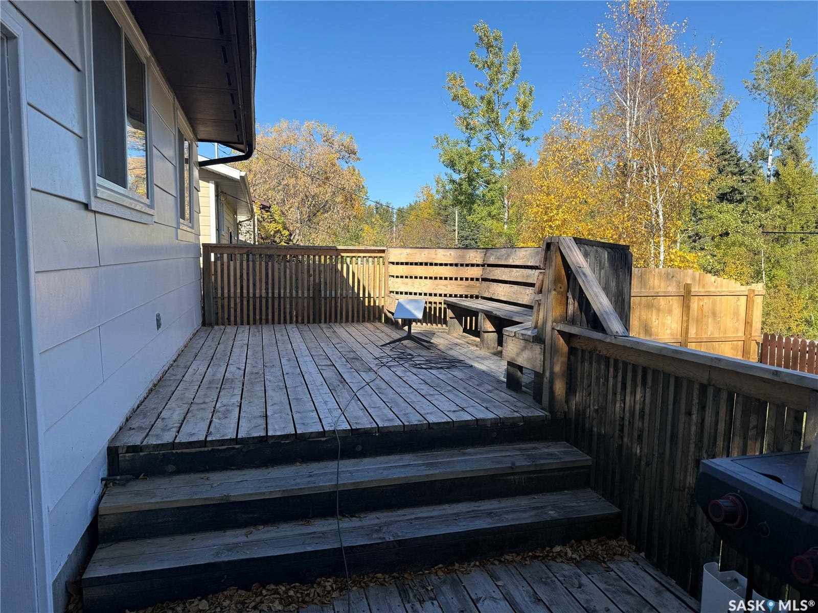 708 Studer Street, La Ronge SK S0J 1L0 Multi-level wood deck with built-in bench seating and wood railing