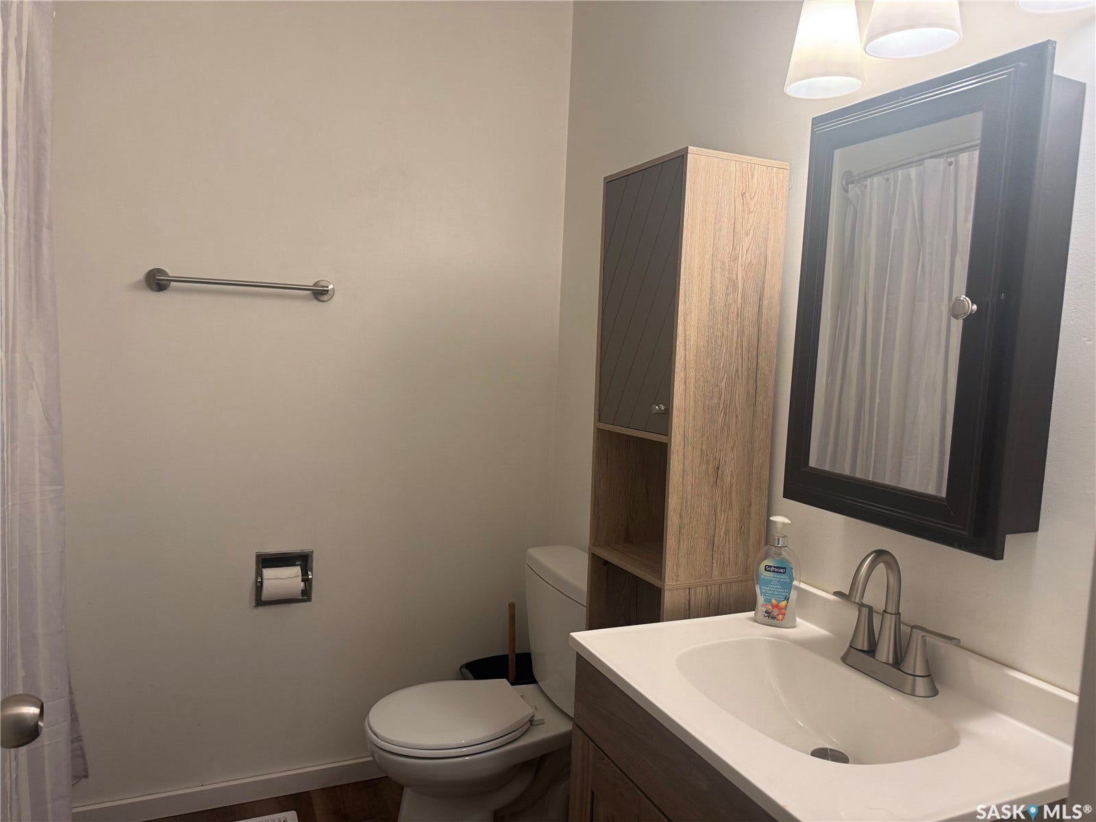 708 Studer Street, La Ronge SK S0J 1L0 Vanity with integrated sink, wall-mounted mirror cabinet, and overhead lighting