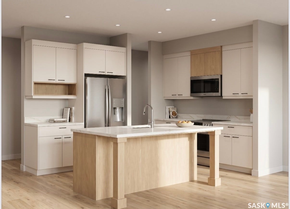 Kitchen featuring a central island, recessed lighting, wood-finish flooring, light-toned cabinetry, and stainless steel appliances