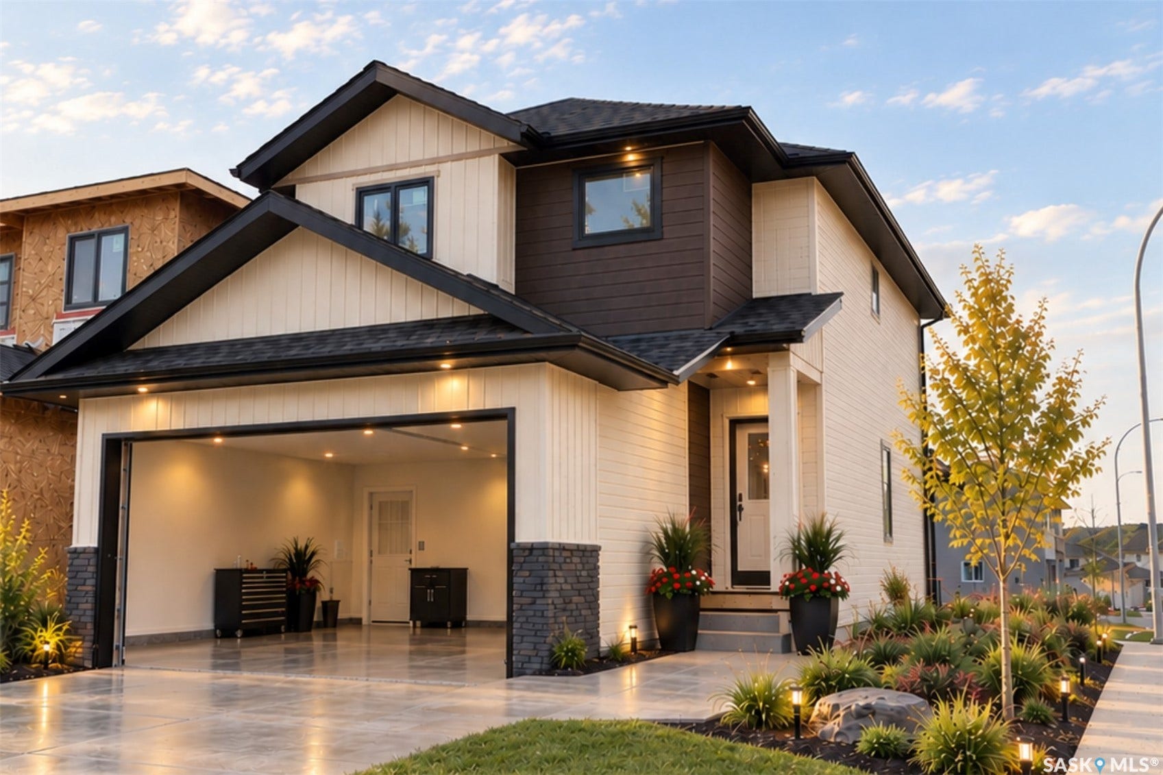 Contemporary exterior with mixed material siding, integrated two-car garage, and a covered entry