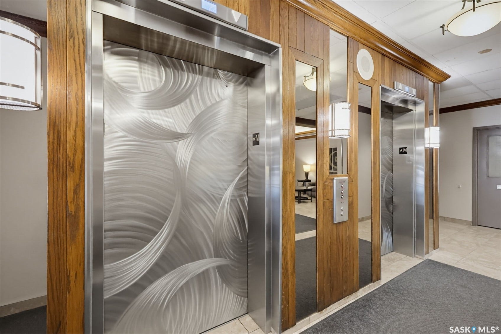 Two stainless steel elevators with decorative finishes