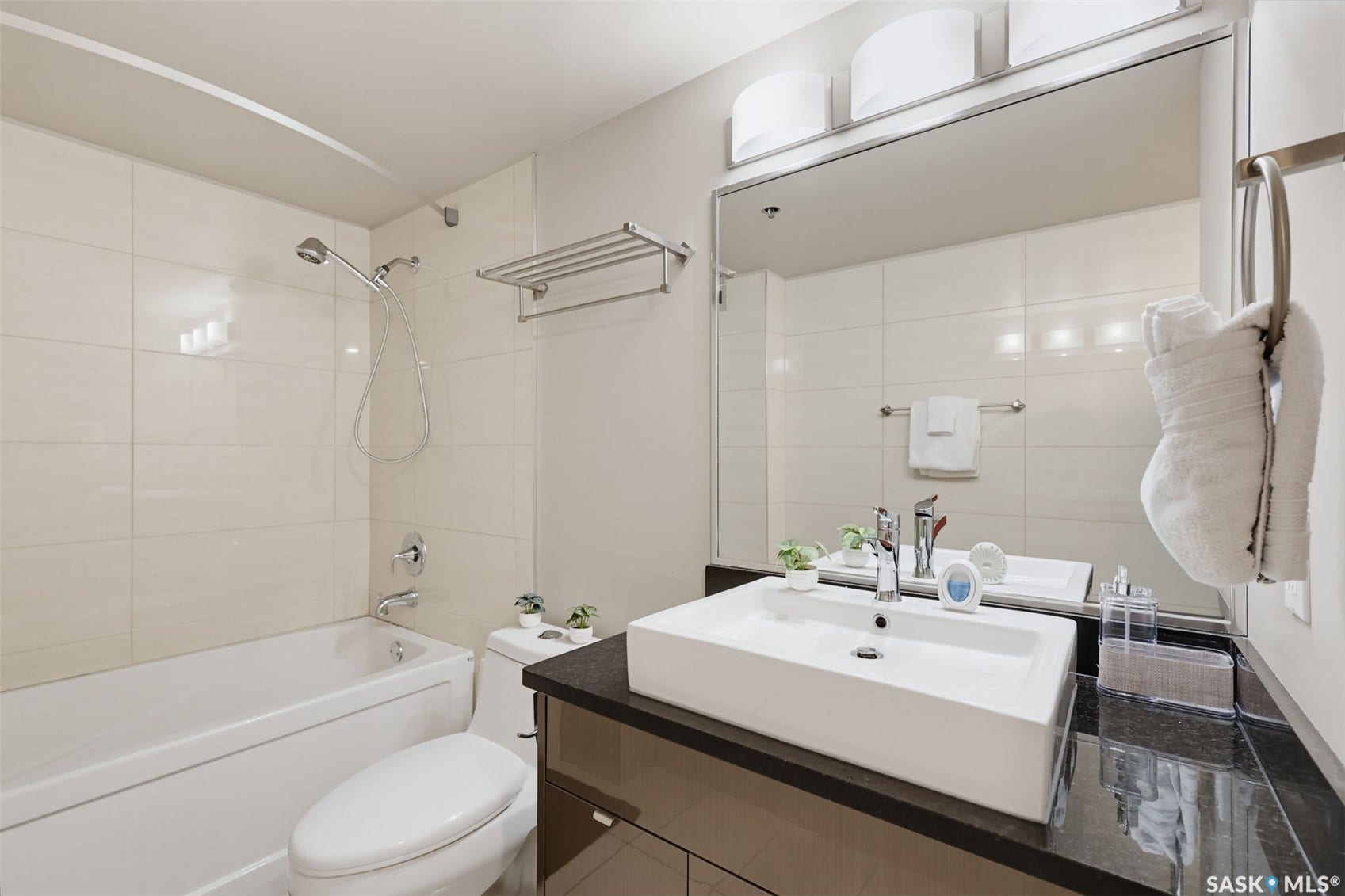 White subway tile shower surround with a tub/shower combination