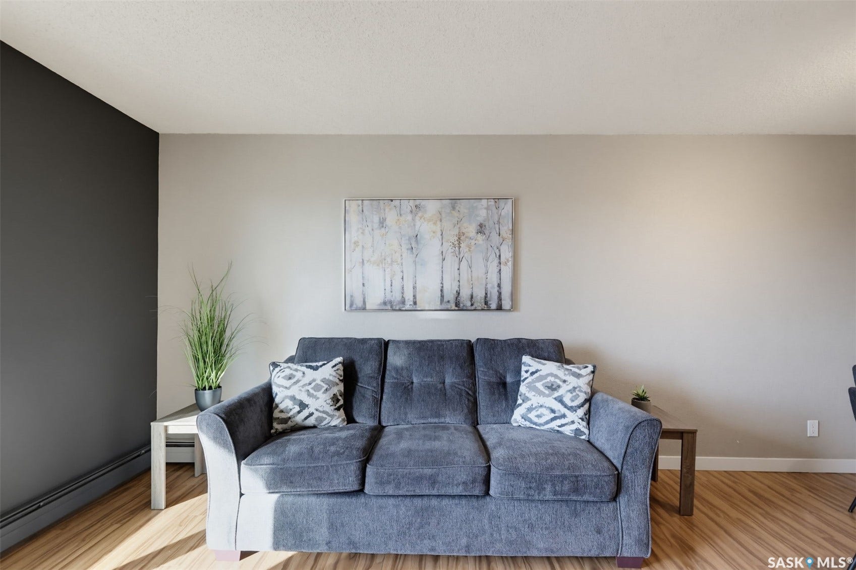 Wood-finish flooring with neutral wall tones and an accent wall