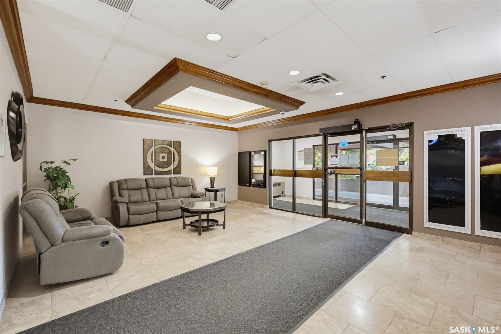 Recessed lighting, tiled flooring, wood trim accents, and glass entry doors