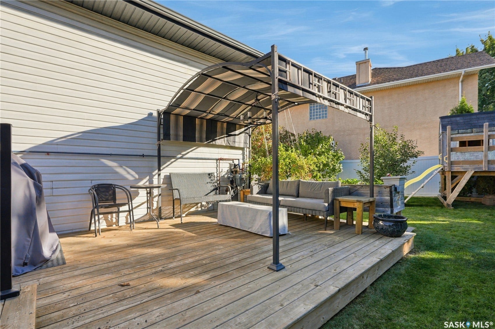 Expansive wood deck with a built-in pergola, offering dedicated outdoor living space