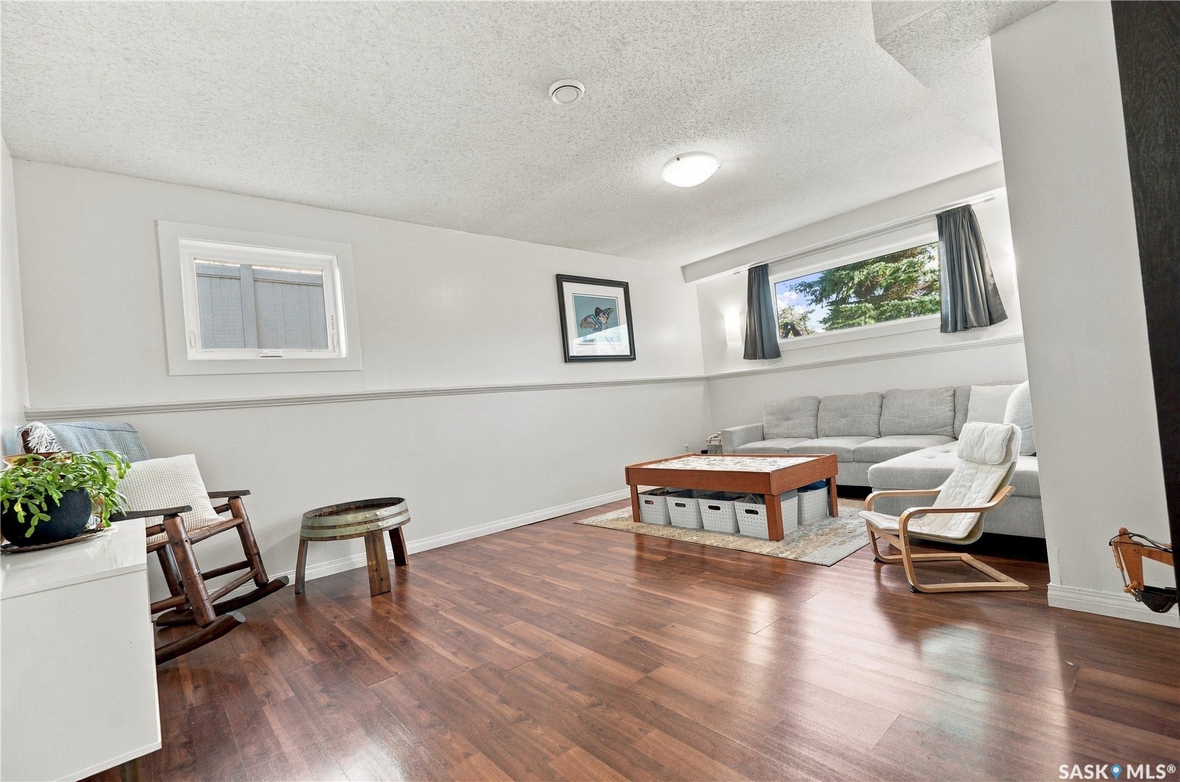 Recessed lighting, wood-finish flooring, white walls, and multiple windows