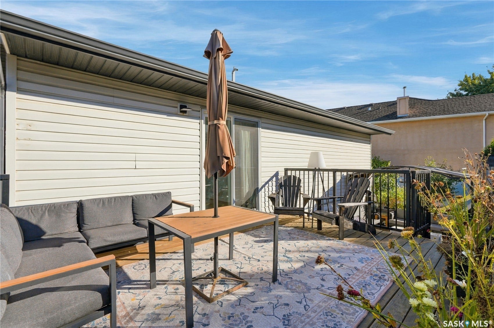 Outdoor deck featuring wood plank flooring and black railing