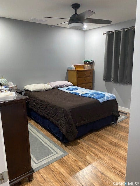 216 2nd Avenue, Wiseton SK S0L 3M0 Wood-finish flooring with a ceiling fan light fixture