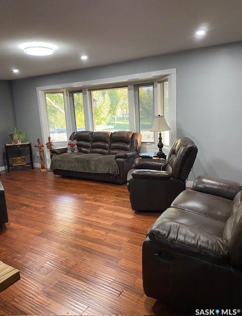 216 2nd Avenue, Wiseton SK S0L 3M0 Recessed lighting, wood-finish flooring, bay window with white trim, light gray painted walls, and a contemporary flush-mount ceiling light