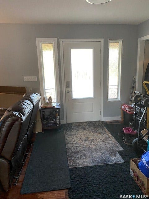 216 2nd Avenue, Wiseton SK S0L 3M0 Entryway featuring a white door with frosted glass, two vertical sidelight windows, and wood-finish flooring