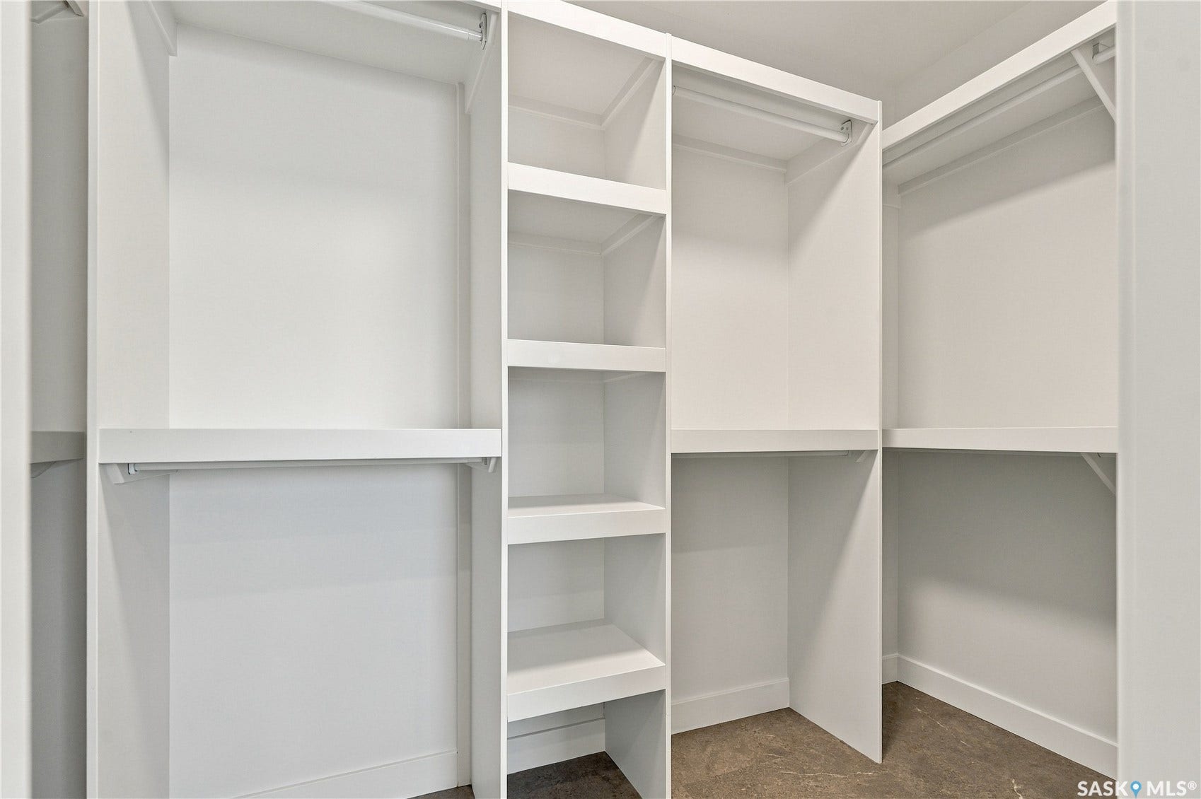 Built-in closet system featuring white shelving and hanging rods