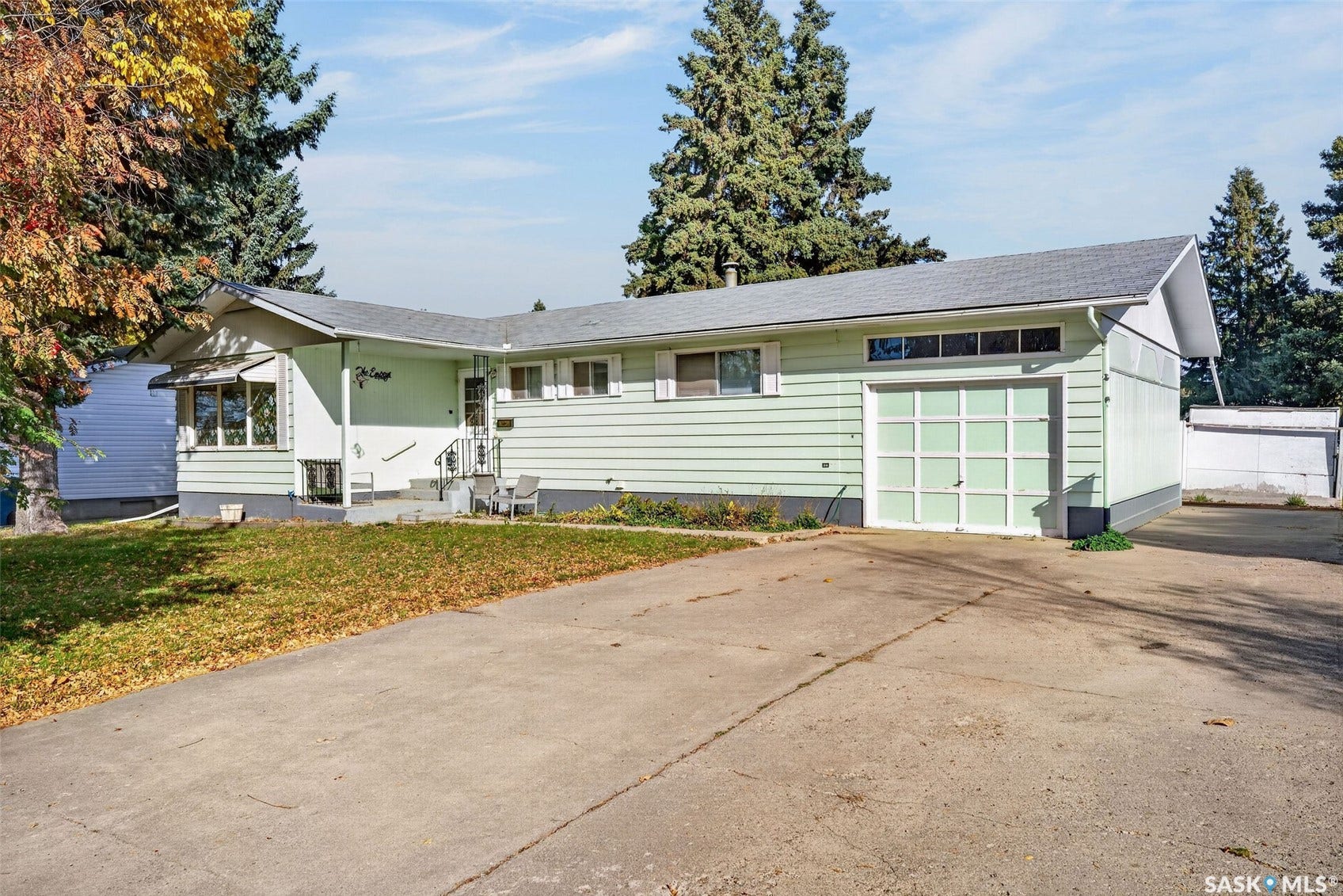 Single-story residence featuring light green siding and white trim