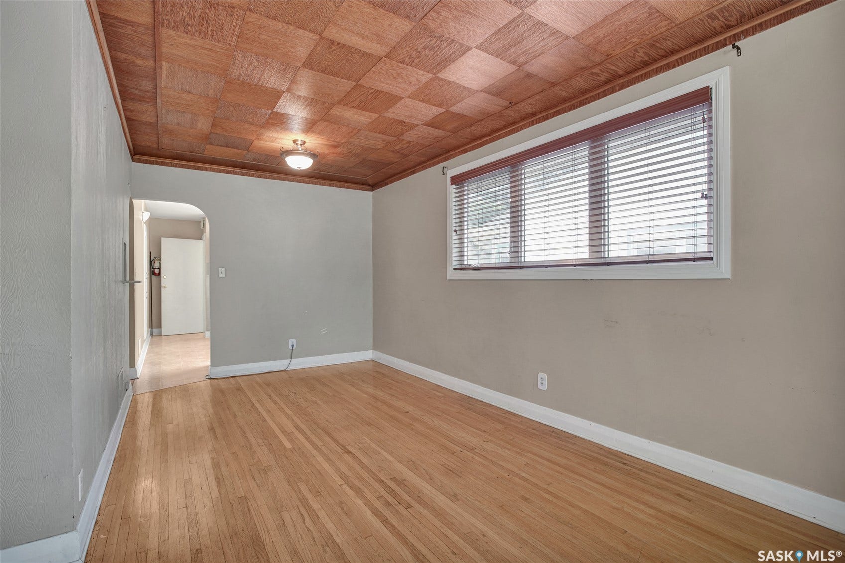 Wood-finish parquet ceiling with a flush-mount light fixture