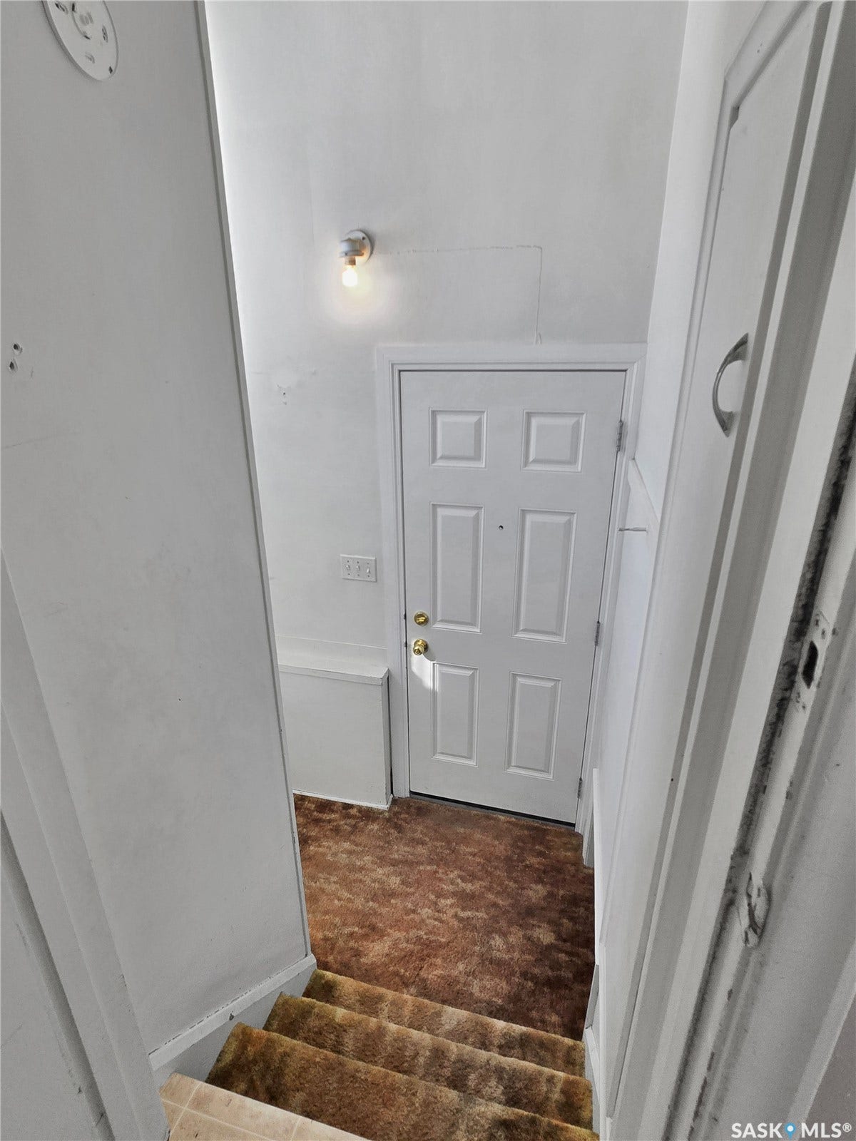 Panel door entry with gold-tone hardware