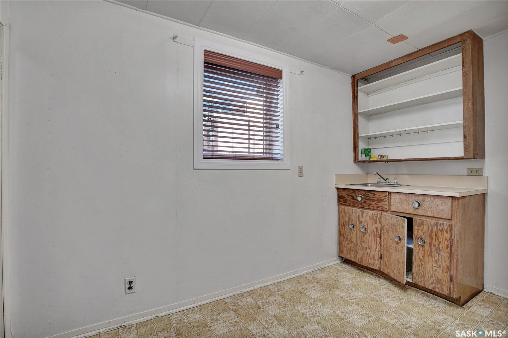Built-in wood-finish cabinetry featuring a countertop and sink