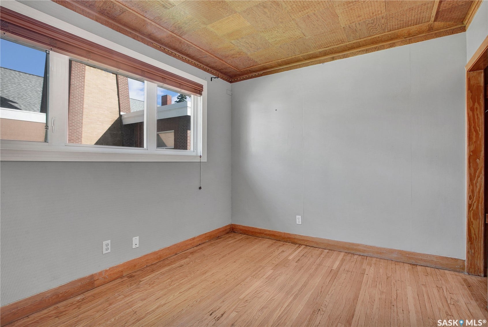 Hardwood flooring, wood-paneled ceiling, trim, and window casing